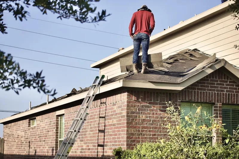 Professional roofer working on a residential roof in Moscow
